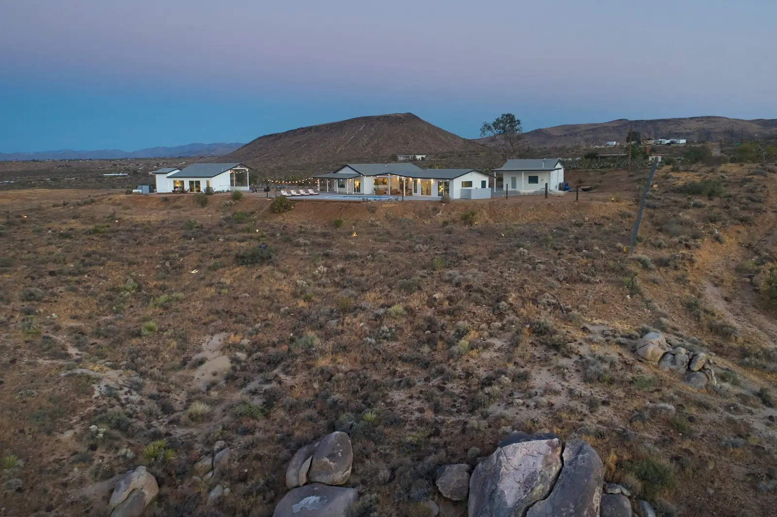 House glowing at dusk against the desert